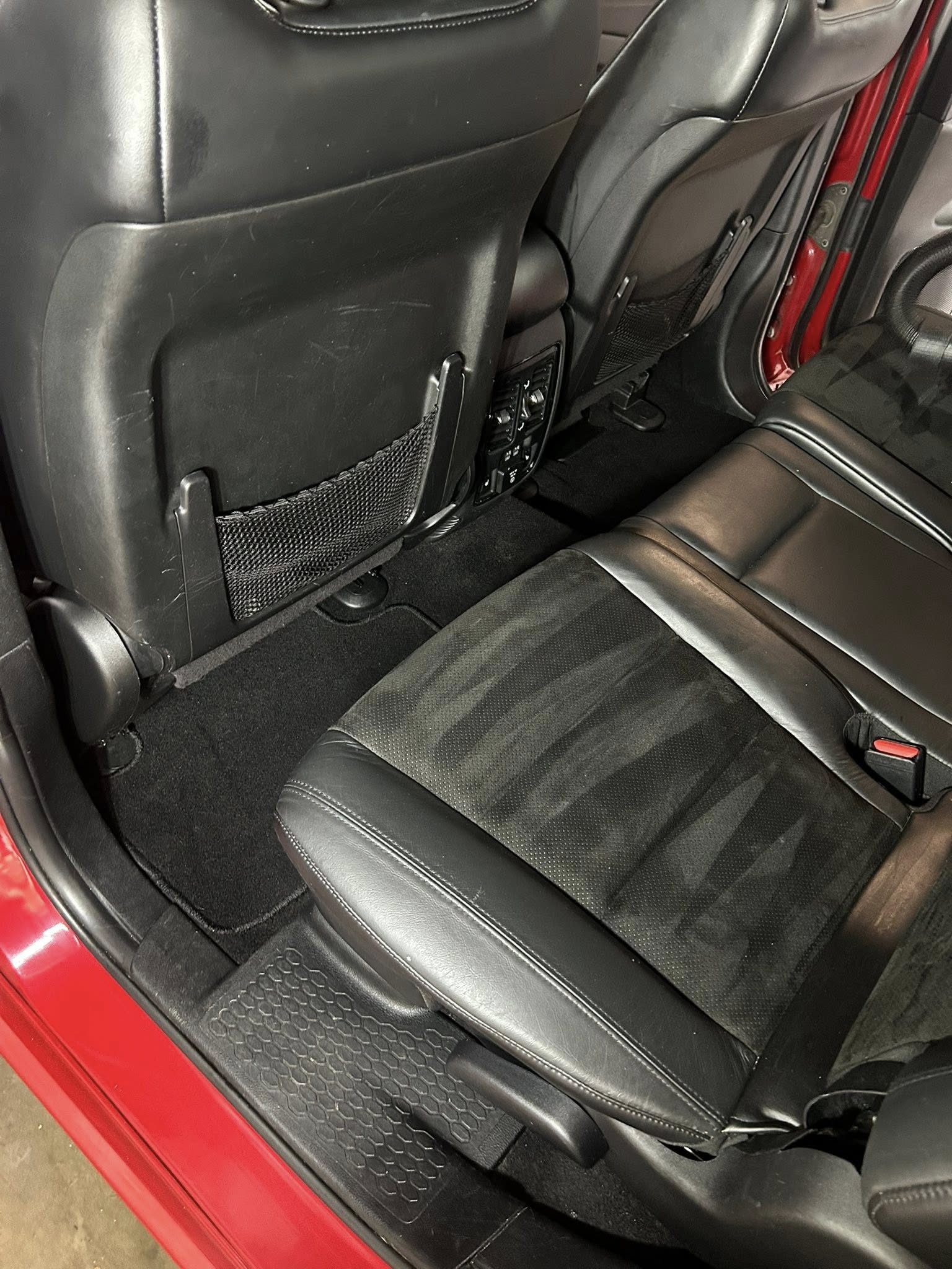 Red car interior after professional cleaning - pristine rear seats