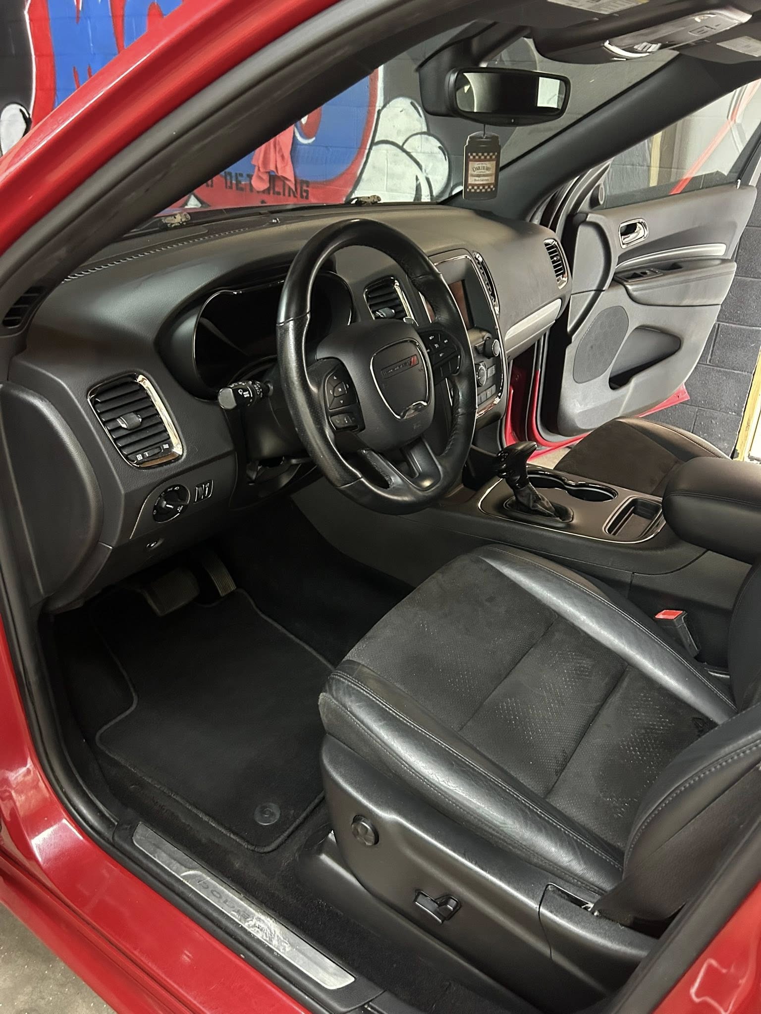 Red car interior after professional cleaning - pristine driver's side
